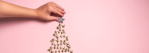 istock Hands decorating golden Christmas tree. View from above. Flat lay 1280937723
