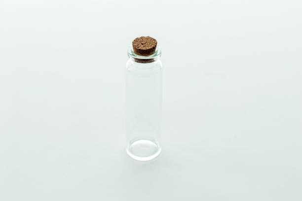 istock Close up view of tall glass empty container for pills on light gray background 1280938949