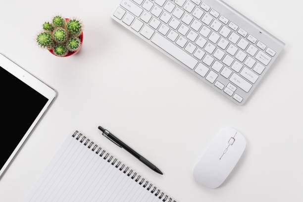 istock White office desk table with blank notebook, computer keyboard and other office supplies. Top view with copy space. 1280941030