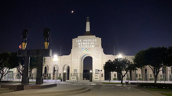 Los Angeles, CA, Jul 2020: entrance to Los Angeles Memorial Coliseum, home of the USC Trojans and the Los Angeles Rams, in Exposition Park at night