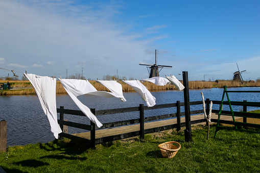 Kinderdyk, Netherlands - March 23, 2019: Laundry flying in the and amidst the windmills in the Kinderdyk region of the Netherlands