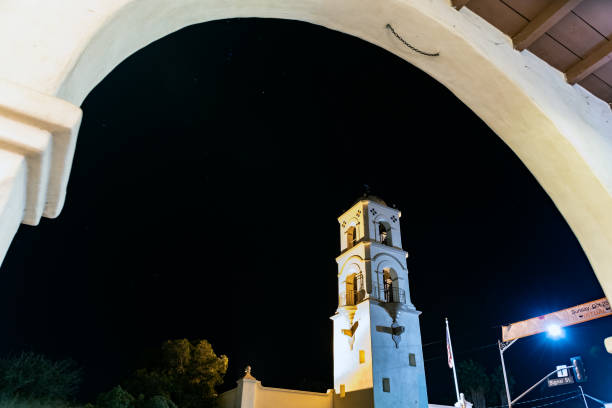 Architectural arch frames the Ojai tower against the night sky twinkling with constellation stars.