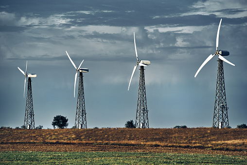 Wind turbines, cloudy dark sky