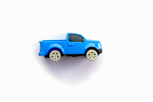 Children s toy little blue car on a white background. Copy space for text