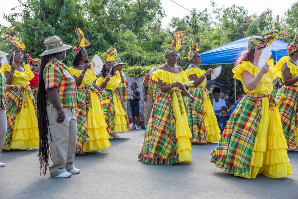 Traditional Caribbean Dancers Frederiksted, St. Croix, US Virgin Islands-January 4,2020: Caribbean parade in downtown Frederiksted with quadrille dancers in beautiful matching outfits and spectators on the west end of St. Croix. quadrille to stock pictures, royalty-free photos & images
