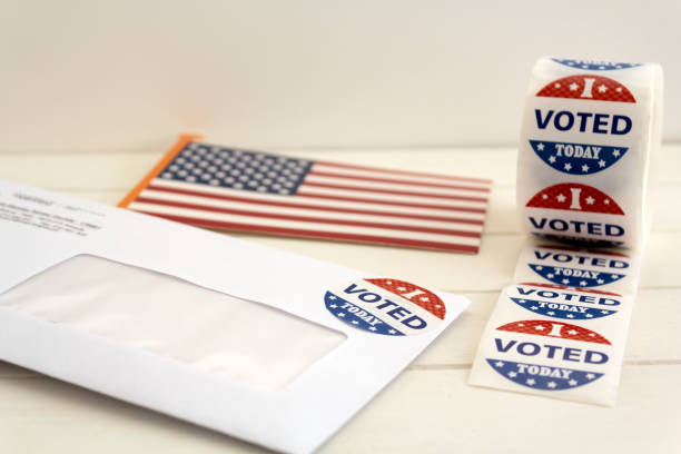 istock Envelope with voting ballot papers sent by mail for absentee vote in presidential election, USA flag and I voted today stickers 1280952227