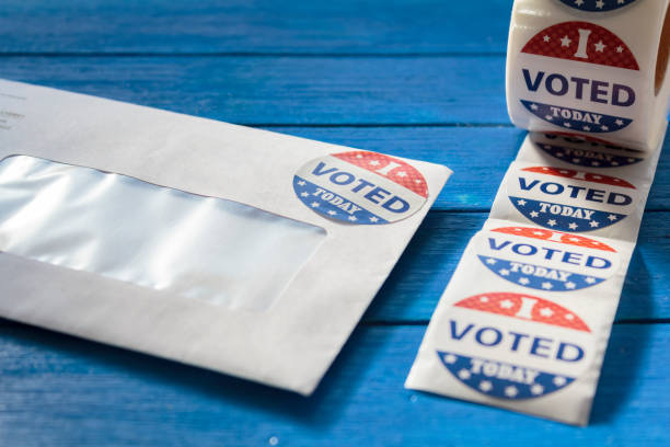 istock Envelope with voting ballot papers sent by mail for absentee vote in presidential election and I Voted today stickers 1280952229