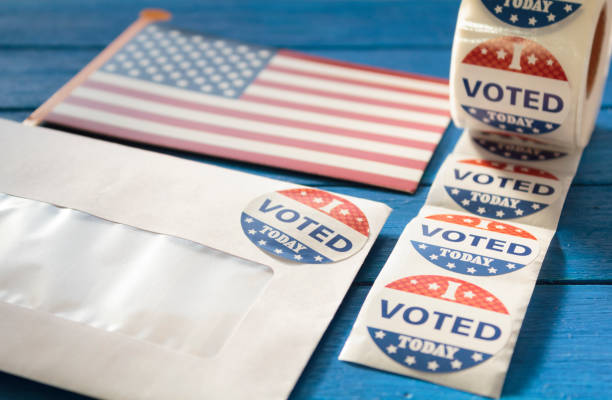 istock Envelope with voting ballot papers sent by mail for absentee vote in presidential election and I Voted today stickers 1280952237