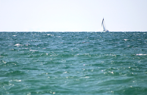 Sailboat on the horizon at Holland State Park, Holland Michigan - Lake Michigan