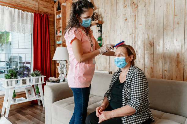 Help in the morning home carer helping senior woman get dressed in her livingroom mental illness photos stock pictures, royalty-free photos & images