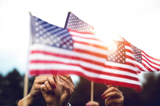 istock Crowd celebrating with national US flag 1280959198