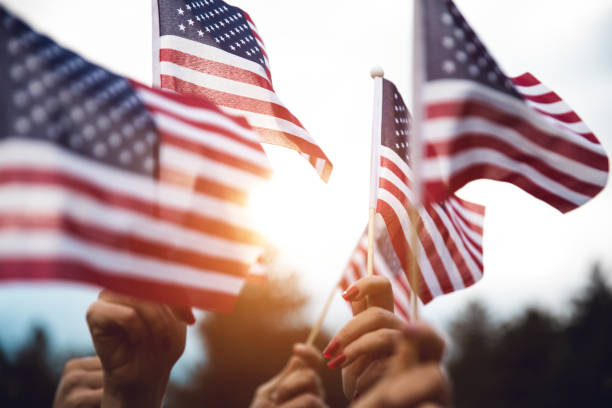 Crowd celebrating with national US flag Group of people celebrating with national US flag veteran stock pictures, royalty-free photos & images