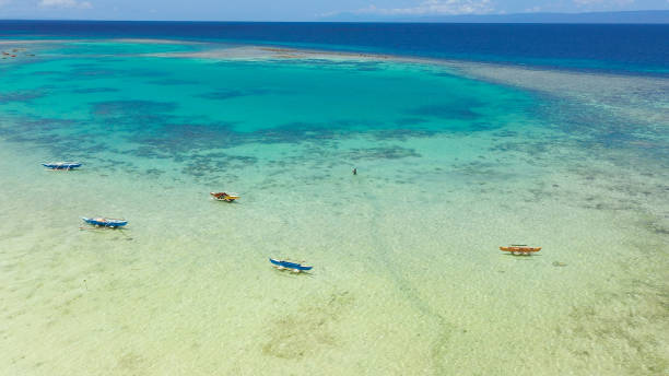 istock Atoll with turquoise water and boats 1280959298