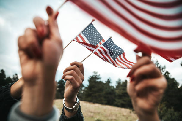 istock Crowd celebrating with national US flag 1280959344
