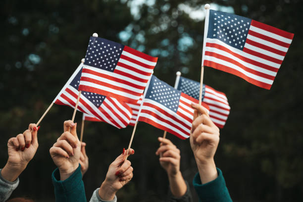 istock Crowd celebrating with national US flag 1280959362