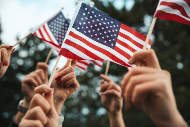 istock Crowd celebrating with national US flag 1280959876