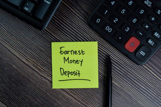 Earnest Money Deposit write on sticky notes isolated on office desk. stock photo