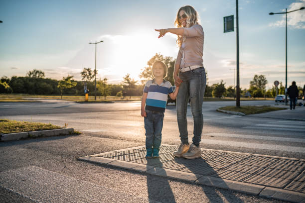 istock Mother and son crossing the road 1280960149