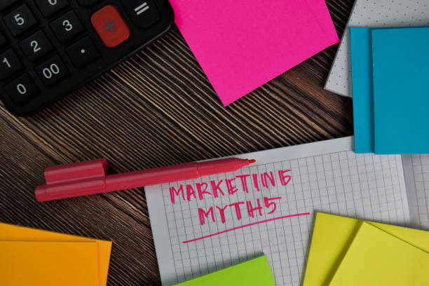 istock Marketing Myths write on a book isolated wooden table. 1280960178