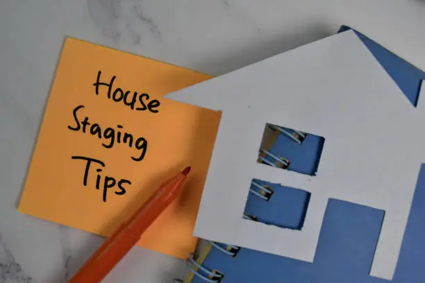 House Staging Tips write on sticky notes isolated on office desk.