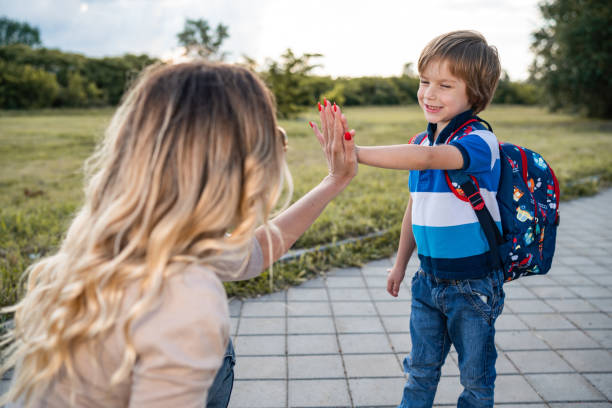 istock Smiling boy give high five his mom 1280960870