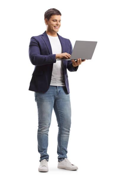 istock Full length portrait of a young man standing and working on a laptop computer 1280960947