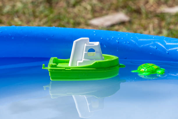 toy plastic boat and turtle in a pool - bath toy imagens e fotografias de stock