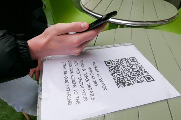 Customer scanning a QR code to register for cafe track and trace