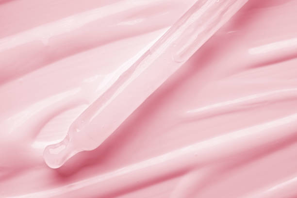 Light pink purple violet cosmetic silky cream milk texture on multi-colored background