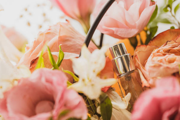 perfume spray bottle decorated flower bouquet. perfume sample. sunlight. soft and tender. romance fragrance concept