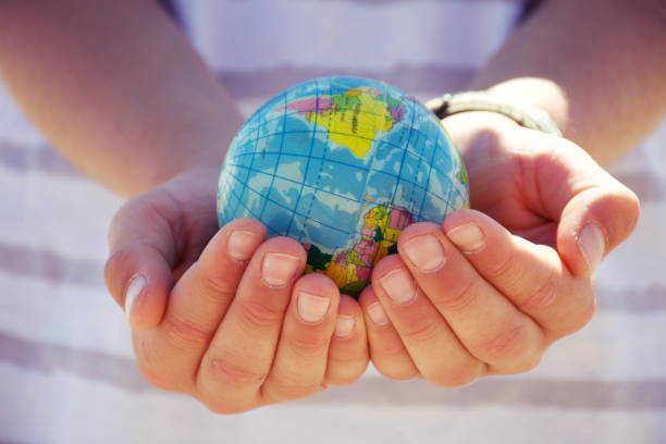 istock Personal Perspective, Child Plays with Globe Ball by Sea 1280969193