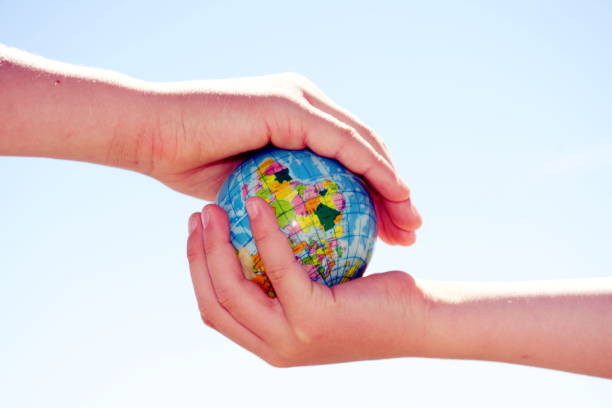 istock Personal Perspective, Children Play with Globe Ball by Sea 1280969216