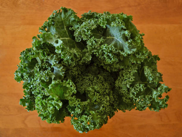 Top view of organic kale on a wooden table stock photo