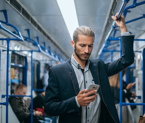 istock business man reading his e-mail correspondence in the subway 1280971615