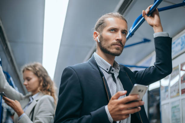 istock passengers in a subway car standing at a safe distance 1280971617