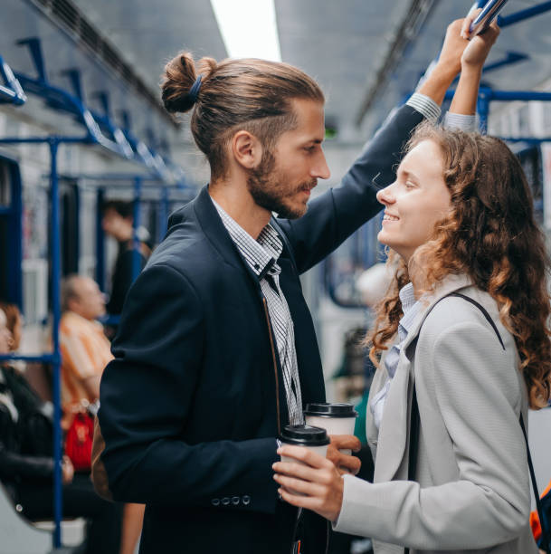 istock young couple with takeaway coffee standing in subway car 1280971706