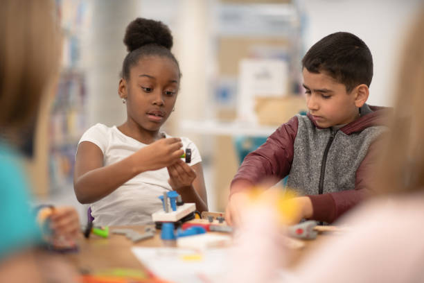 istock Kids working and playing together in school 1280974886