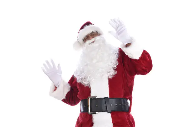 Senior man in traditional Santa Claus costume with hands in the air acting surprised or shocked. Isolated on white.