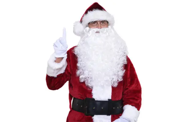 Senior man in traditional Santa Claus costume with one finger pointing up. Number one concept.