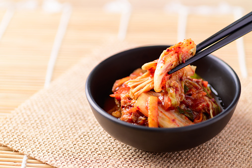 Korean food, Kimchi cabbage in a bowl eating with chopsticks