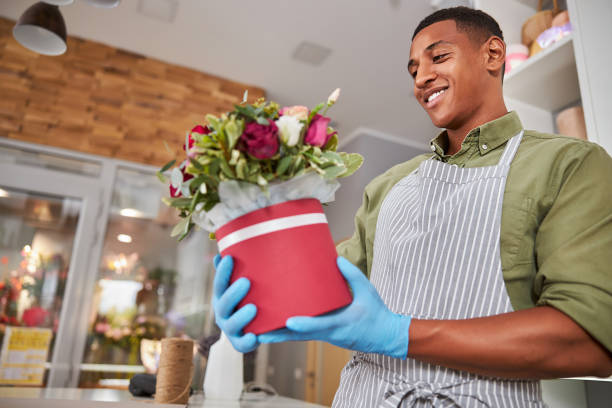 istock Floral artist looking proudly at his work 1280979312