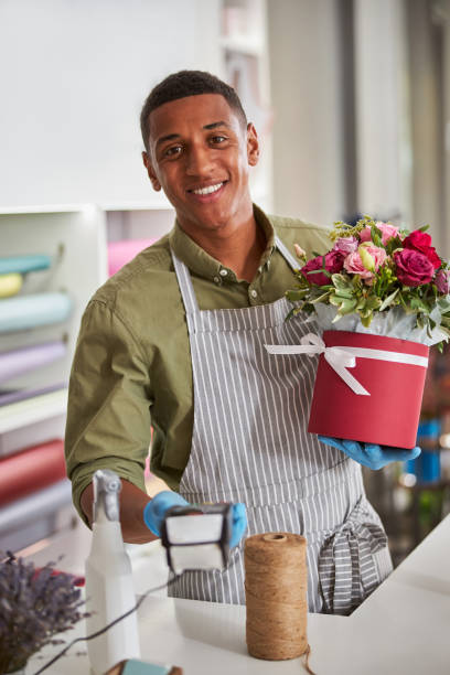 istock Excited florist providing a plastic card reader to a buyer 1280979326