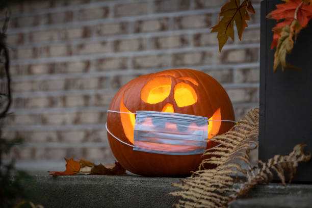 istock Coronavirus Halloweeen Pumpkin or Jack O'lantern with Protective Face Mask 1280982623