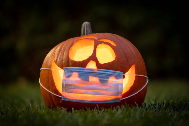 istock Coronavirus Halloweeen Pumpkin or Jack O'lantern with Protective Face Mask 1280982689