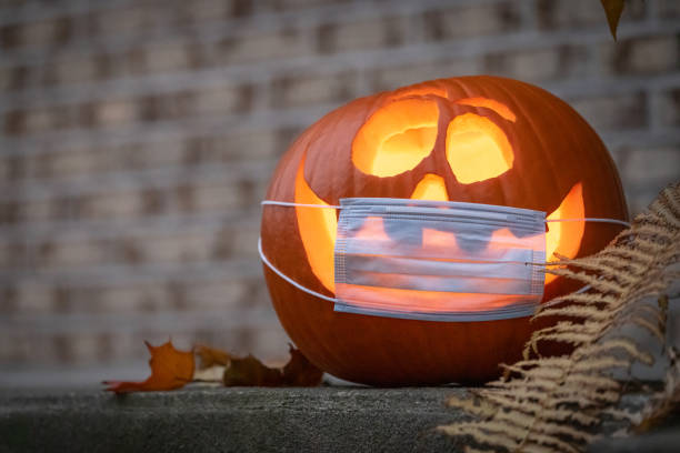 istock Coronavirus Halloweeen Pumpkin or Jack O'lantern with Protective Face Mask 1280982704