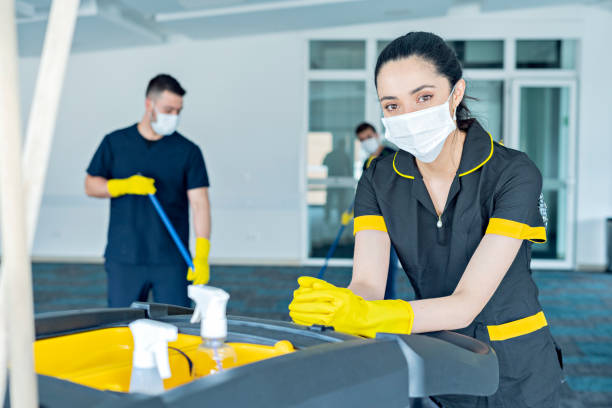 istock Three hotel cleaners cleaning common areas with their masks on. 1280982750