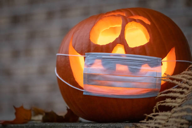 istock Coronavirus Halloweeen Pumpkin or Jack O'lantern with Protective Face Mask 1280982798