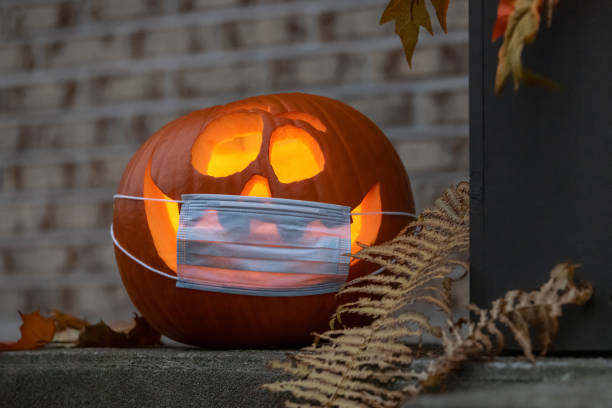 istock Coronavirus Halloweeen Pumpkin or Jack O'lantern with Protective Face Mask 1280983357
