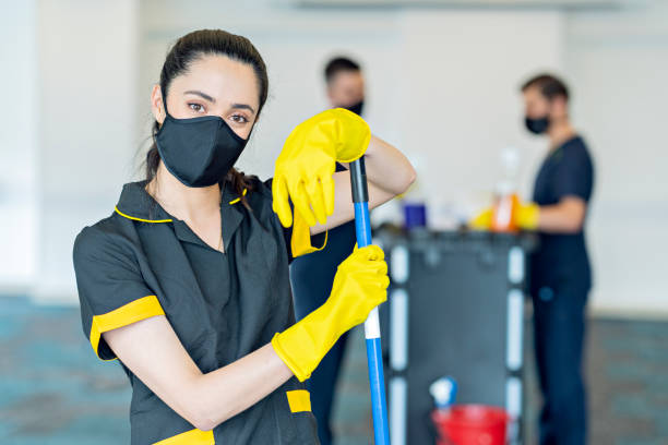 istock Three hotel cleaners cleaning common areas with their masks on. 1280984173