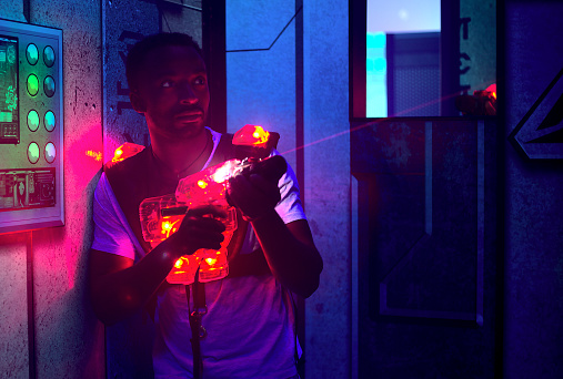 player holding laser gun in entertainment center playing game